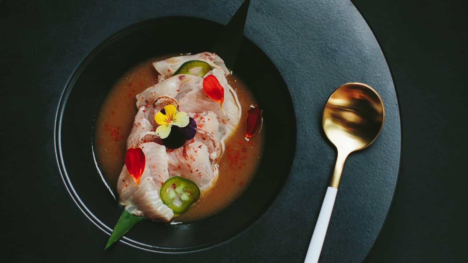 Kona Kanpachi crudo, garnished with flowers and spices