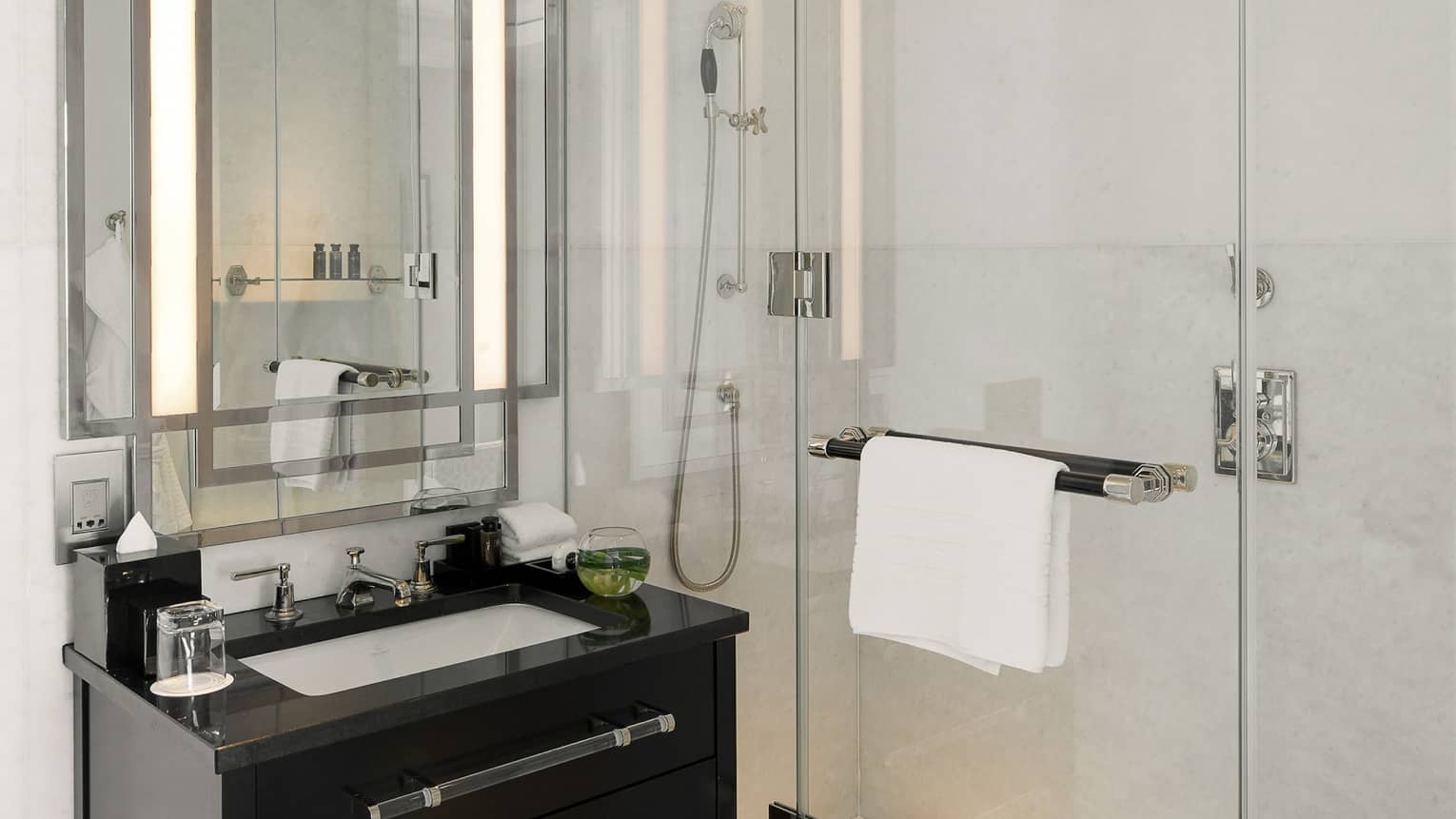 Marble bathroom with dark wood vanity and walk-in shower
