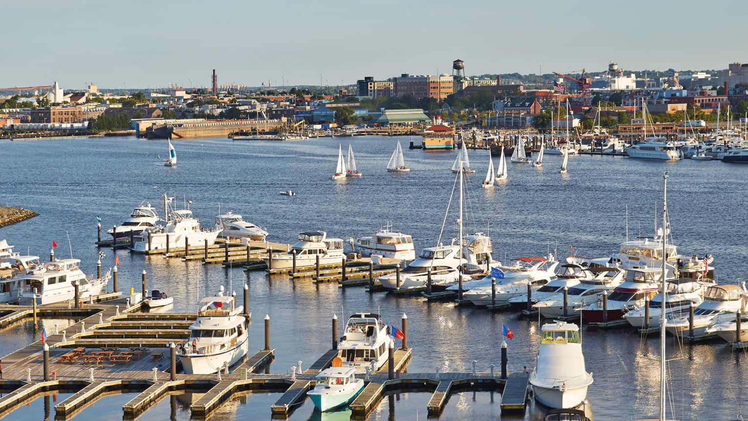 Looking down over boats, docks in Baltimore harbour on sunny day