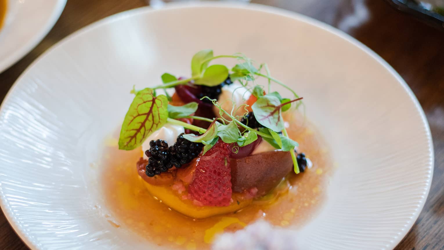 A small salad on a white plate.