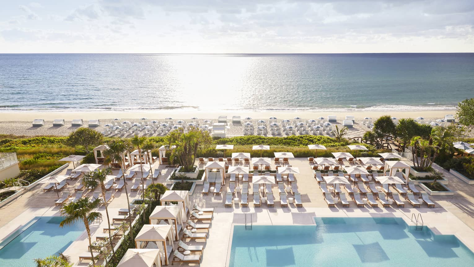 Aerial view of sprawling Four Seasons Resort Palm Beach pool, patio and beach by ocean