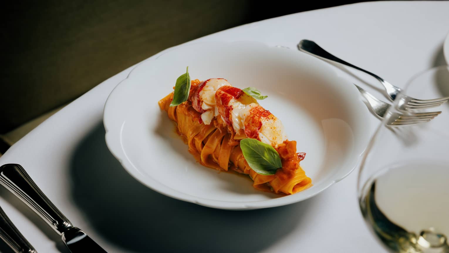 Tagliatelle, Maine lobster and Trapanese pesto served in a white bowl
