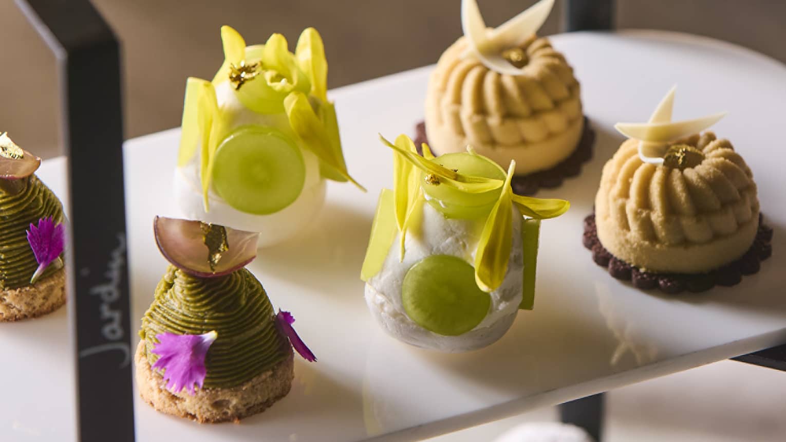 Small savoury bites on tiered display for afternoon tea service