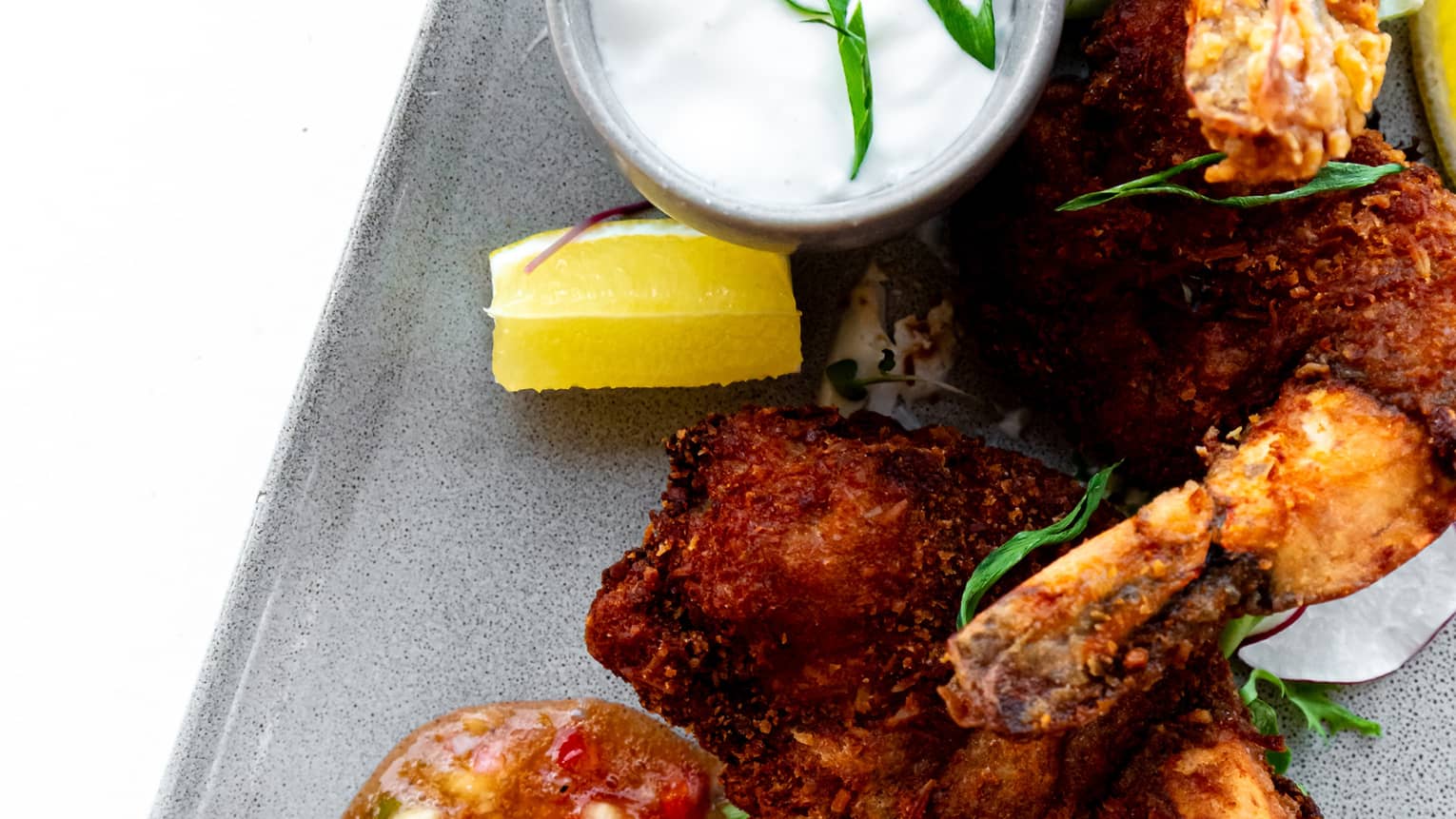 Coconut-breaded shrimp with a bowl of sauce