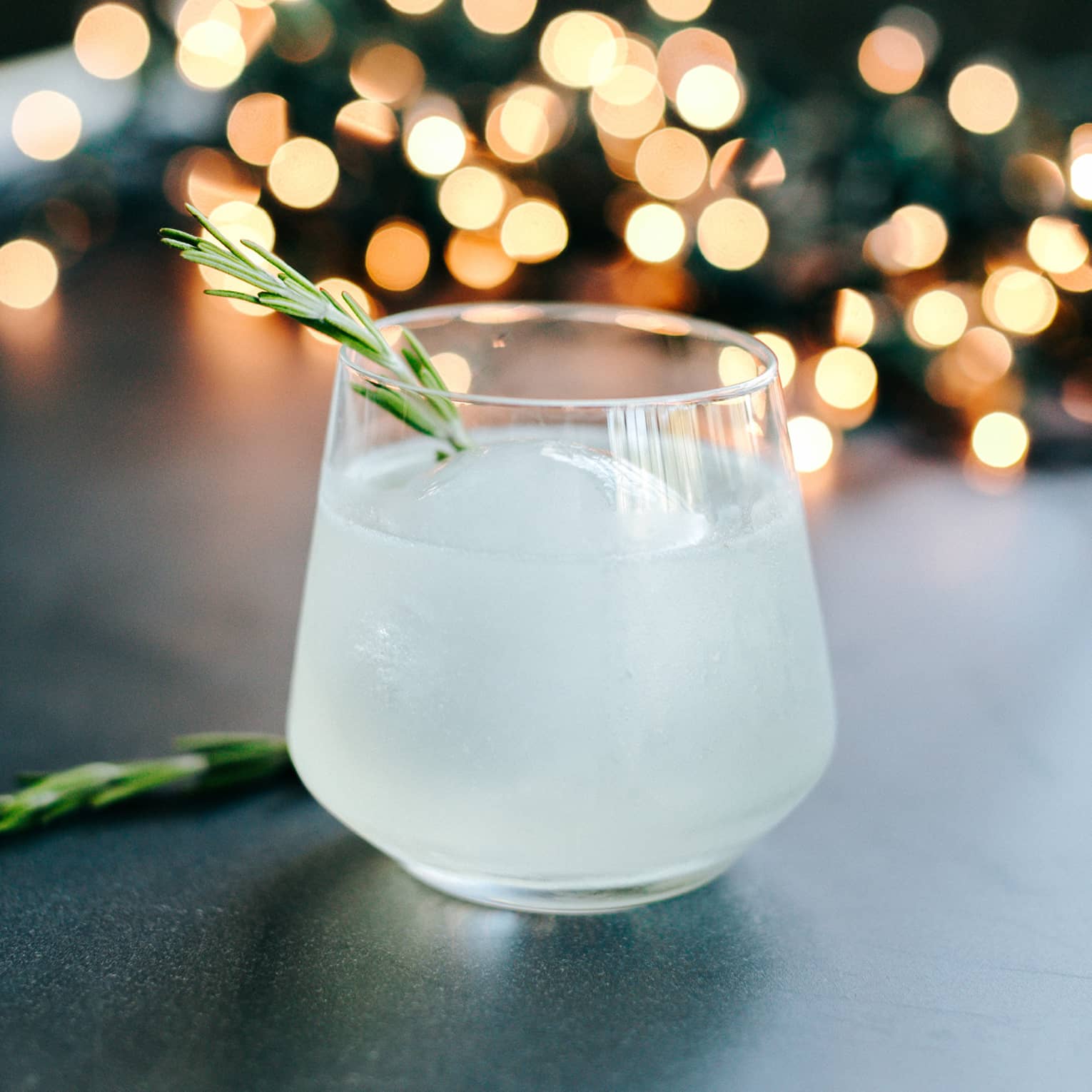 A white cocktail with lights behind it.