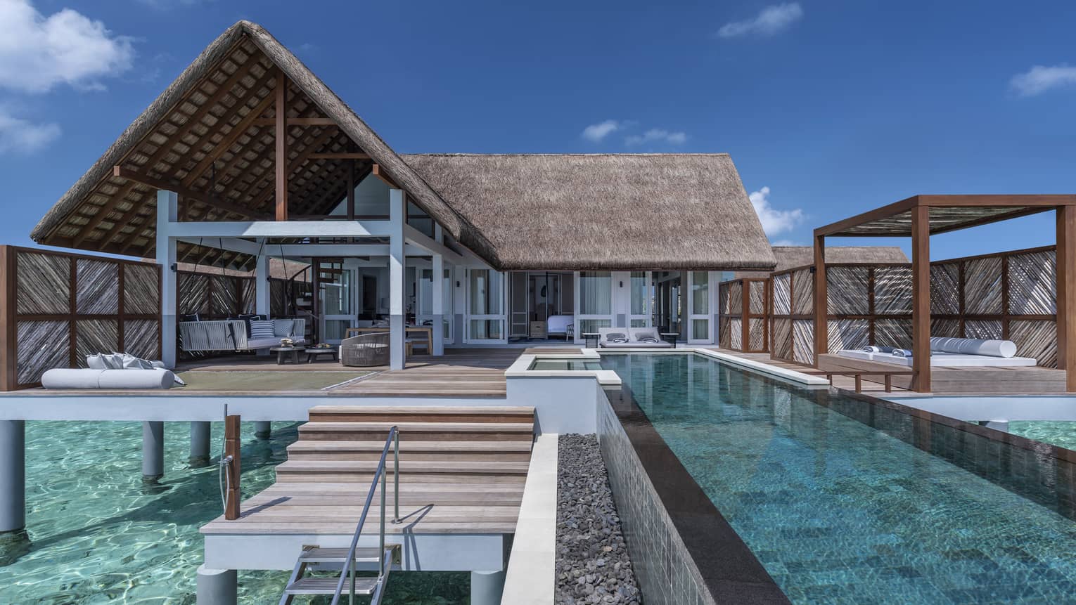 Over-water villas with private pools and furnished decks