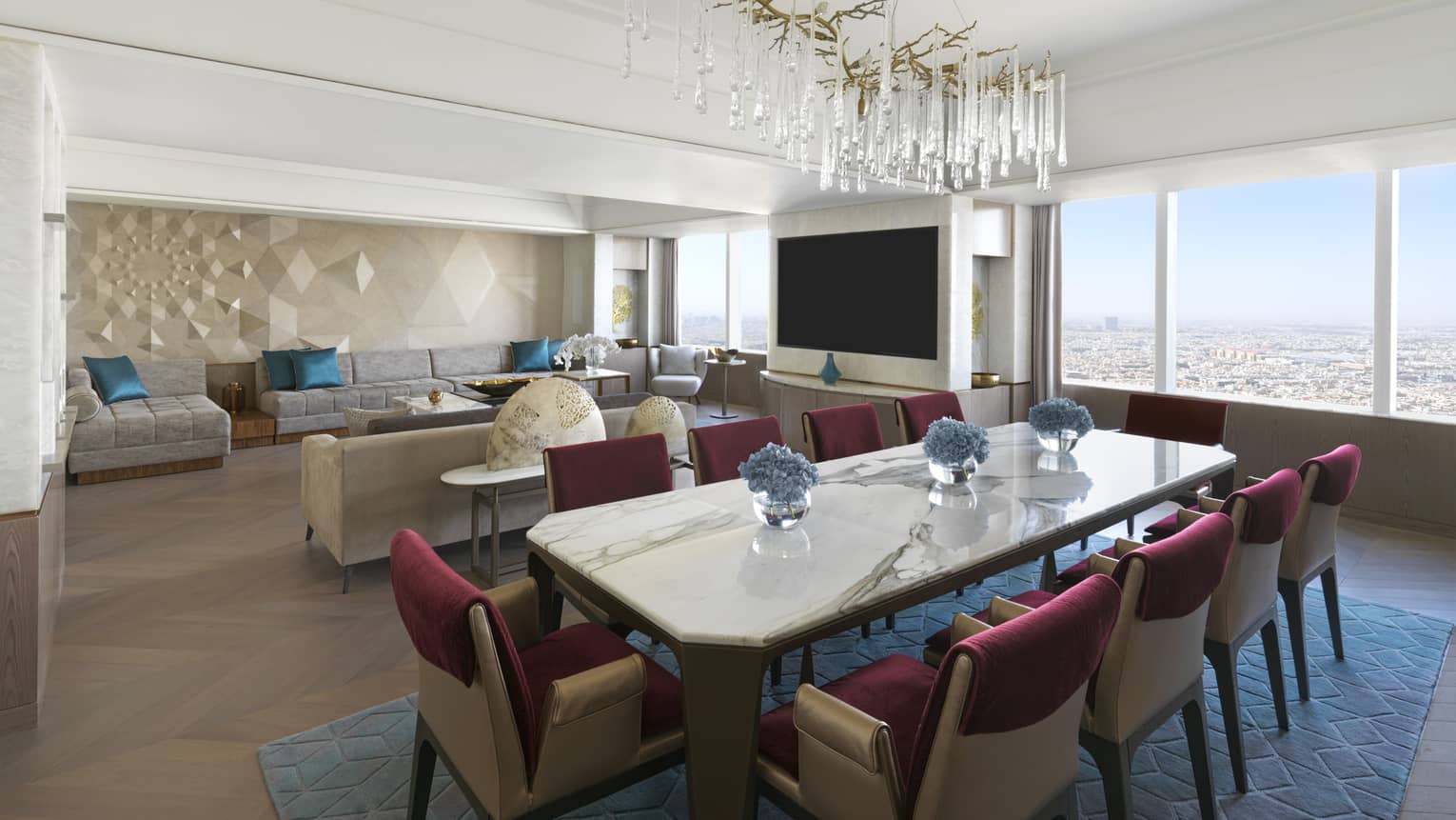 Dining room with marble table set for 10, crystal chandelier and living room