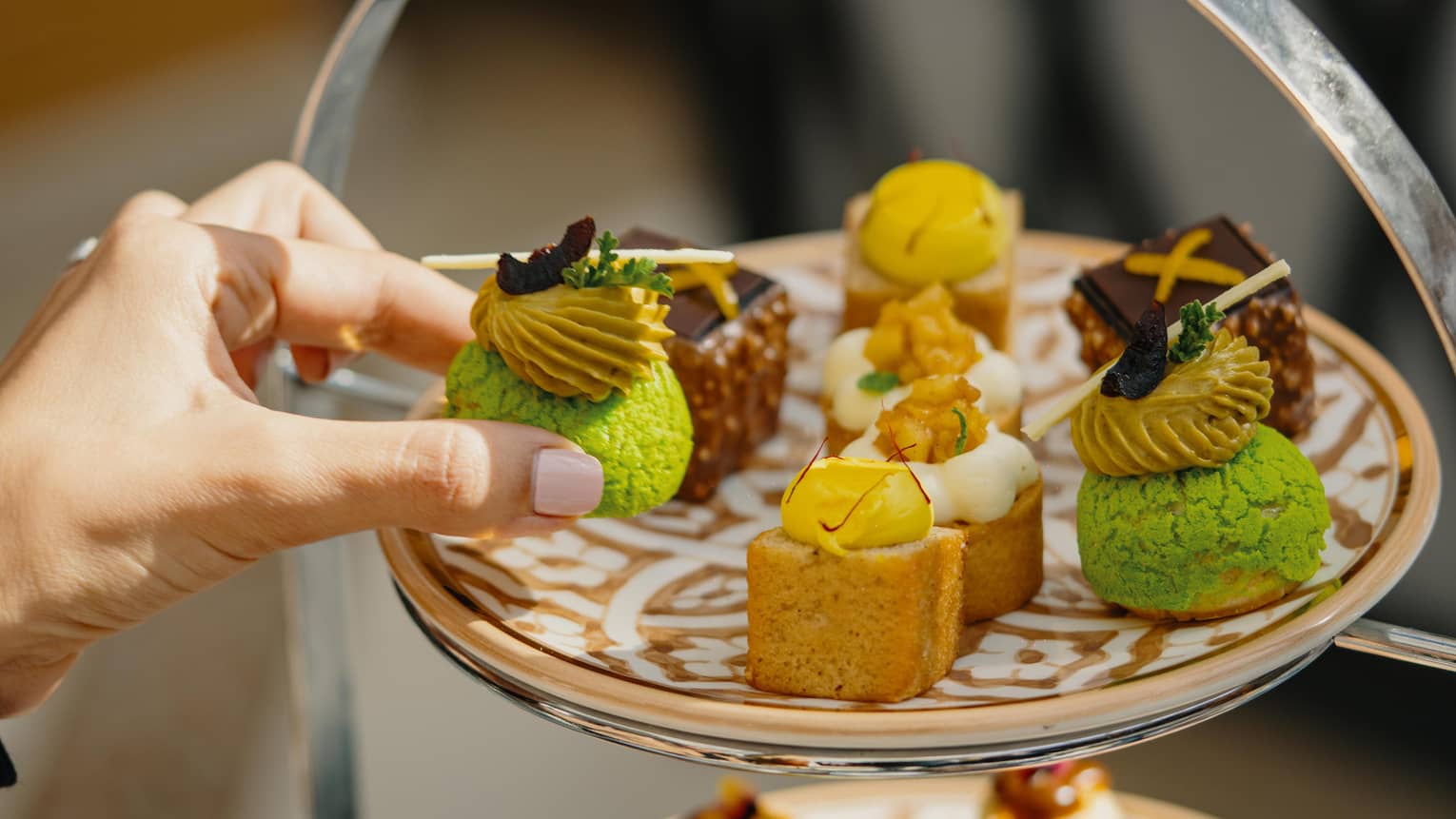 A spread of pastries on a three-tiered stand