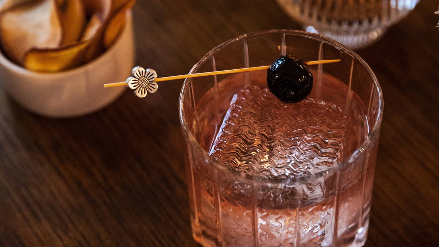 A cocktail with a cherry garnish.