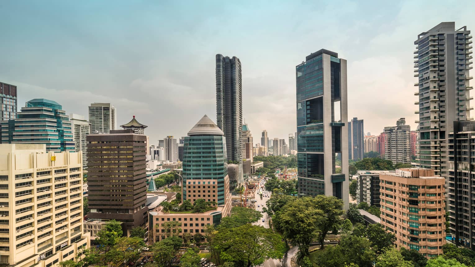 Scenic city view showcasing modern skyscrapers and lush greenery.