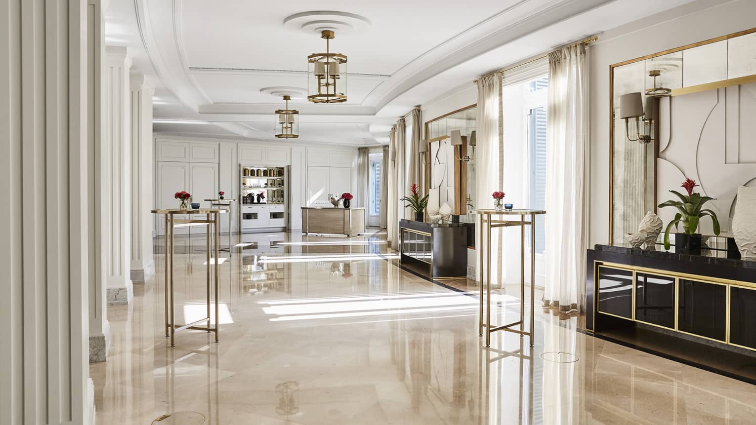 Spacious salon, marble floors, hanging chandeliers, windows