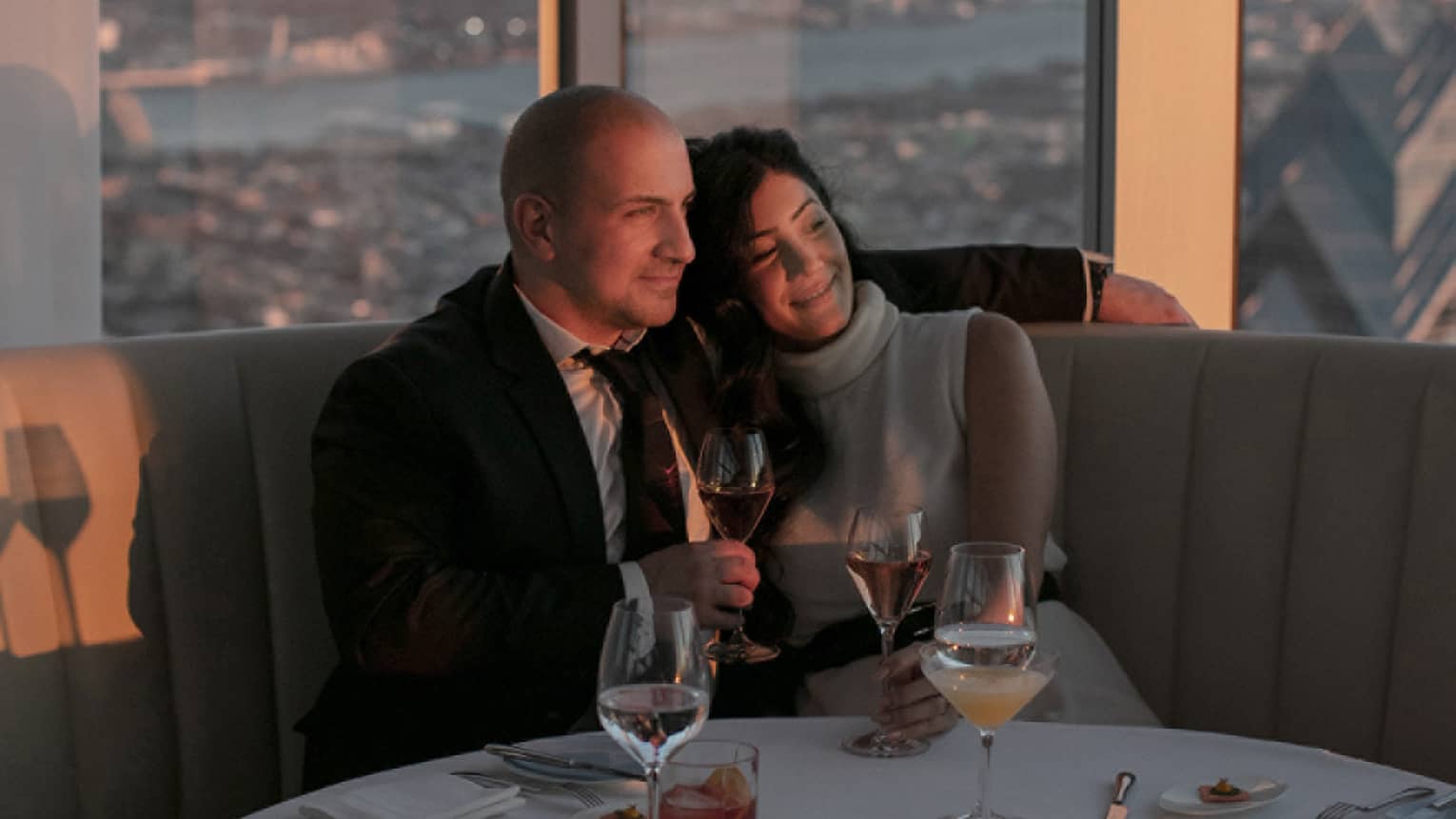 A man and woman drinking wine.