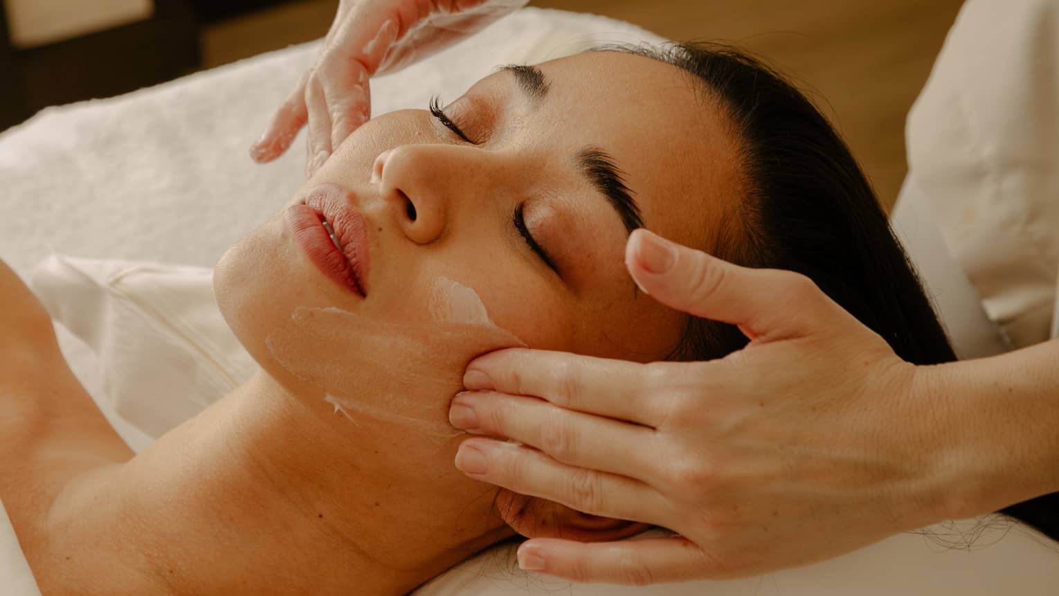Close up of woman's face getting a facial