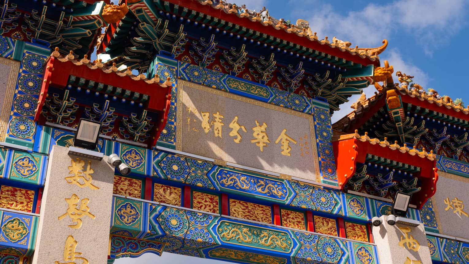 Ornate entrance to a temple in Hong Kong, Wong Tai Sin, with blue and red colours and gold writing