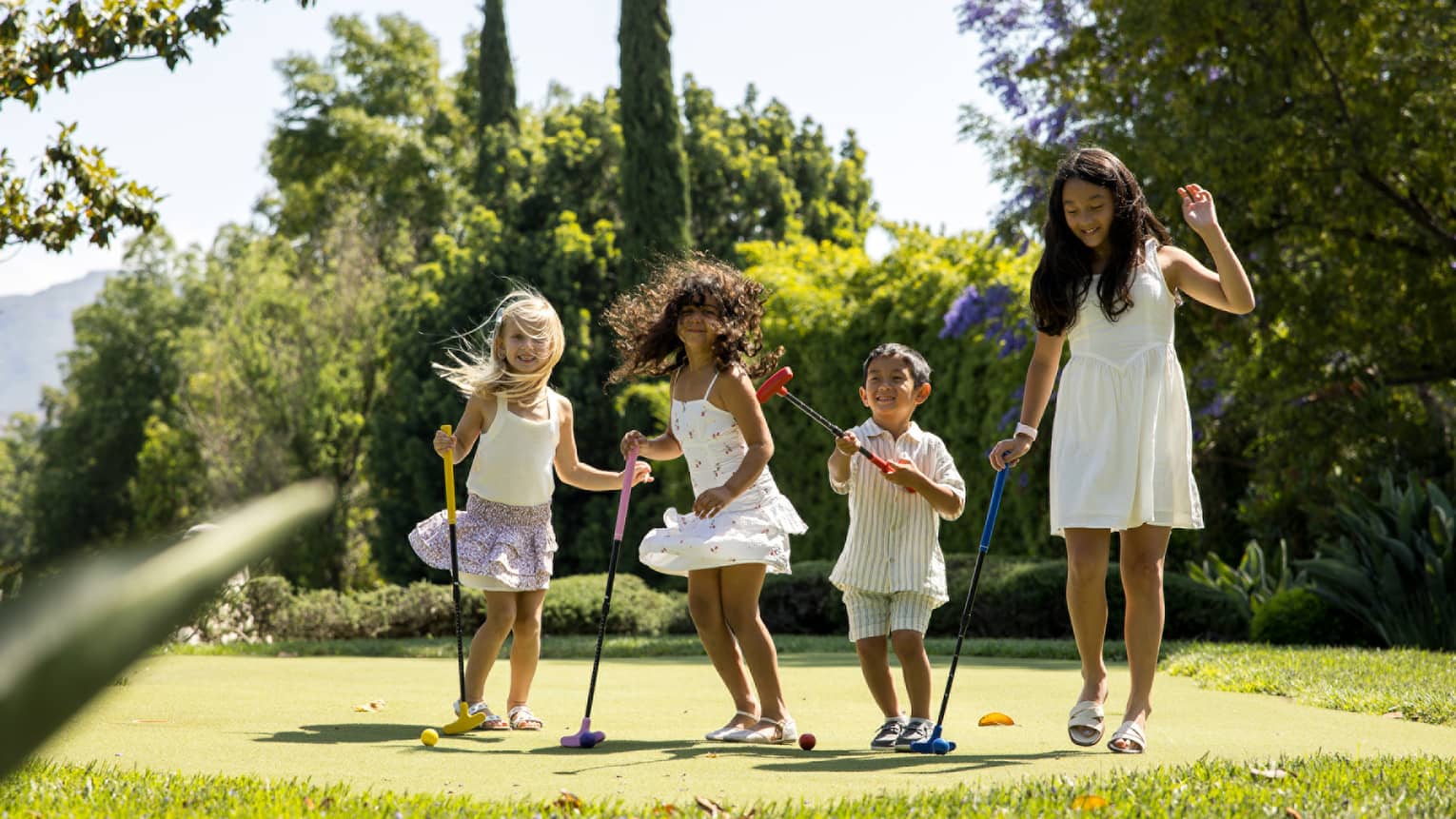 Kids on a golf putting green