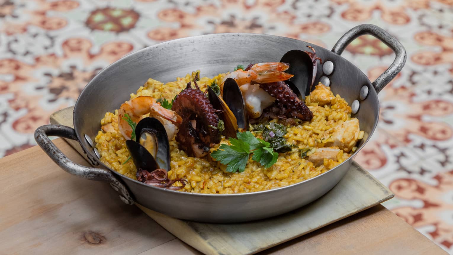 A metal pan with rice and seafood.