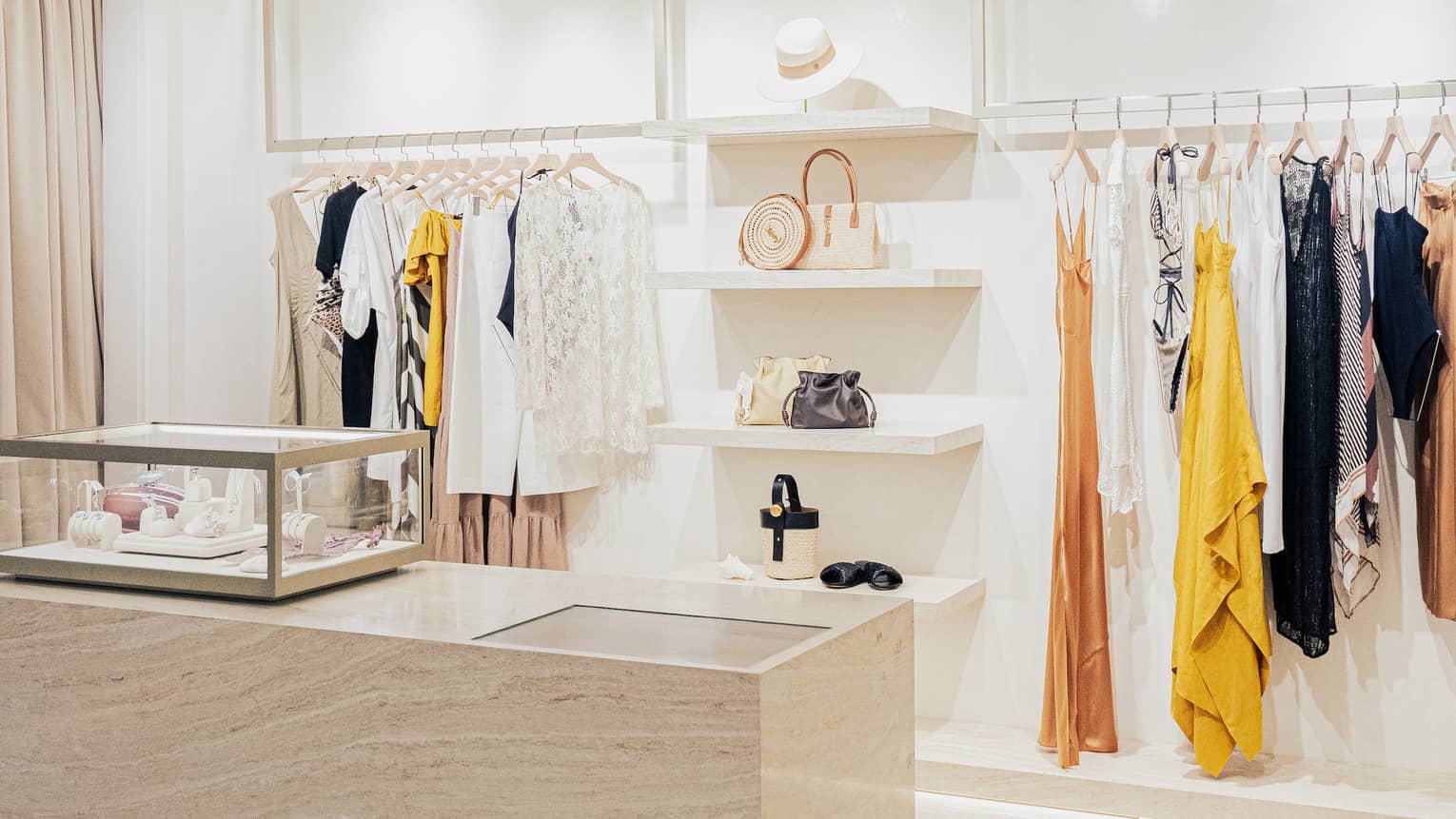 Contemporary boutique with white shelving and stylish clothes