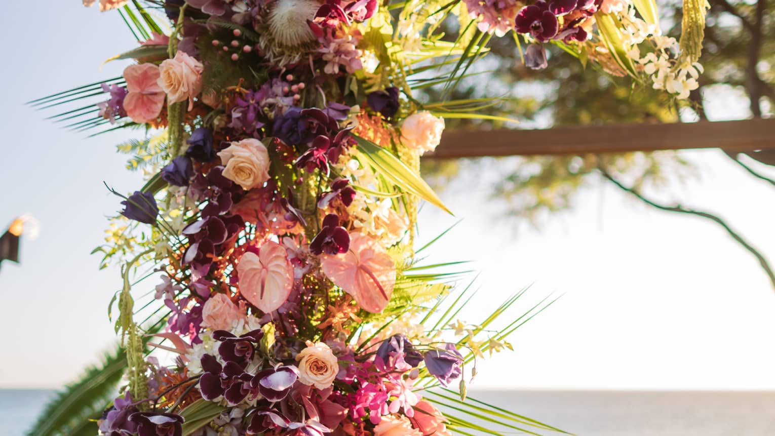 Flowers adorned on wooden arch in Lanai, setting the scene for a wedding proposal