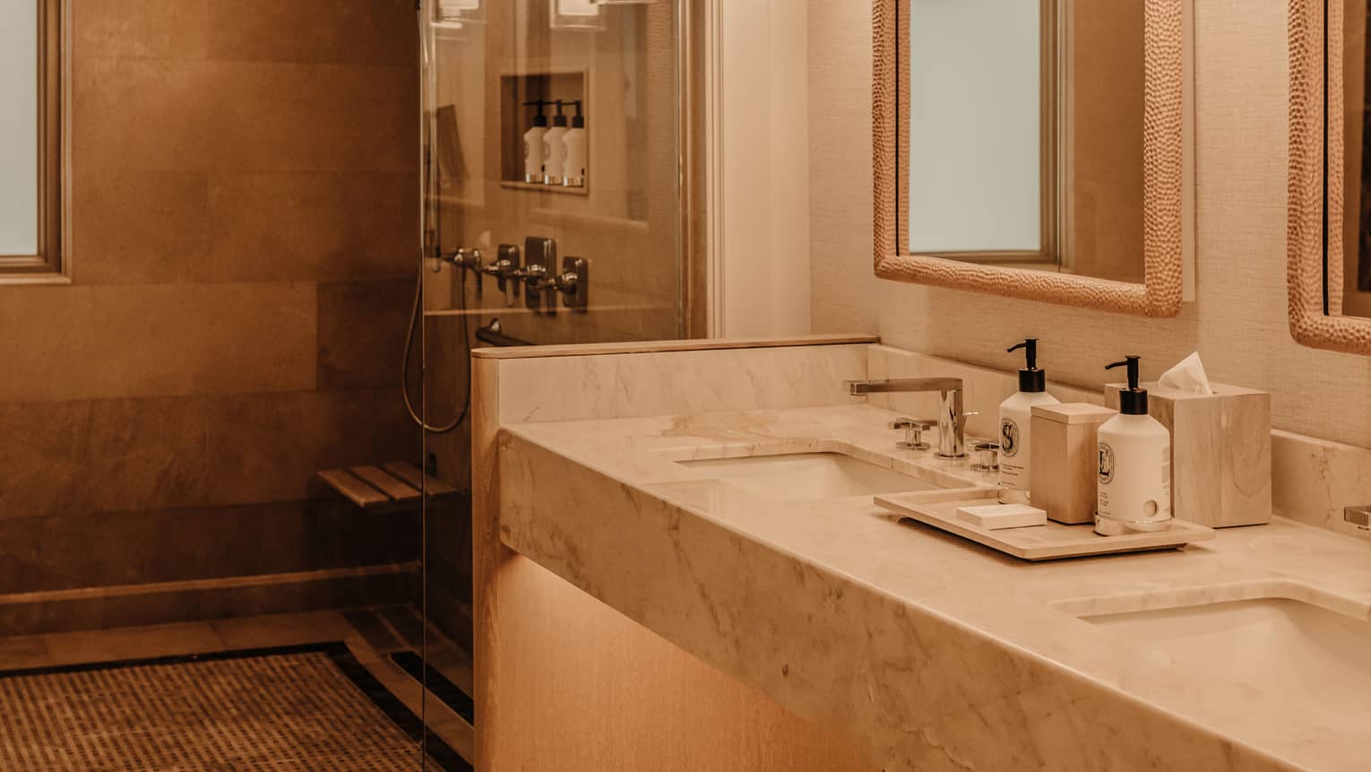 Mobility-accessible bathroom featuring a double-vanity and roll-in shower