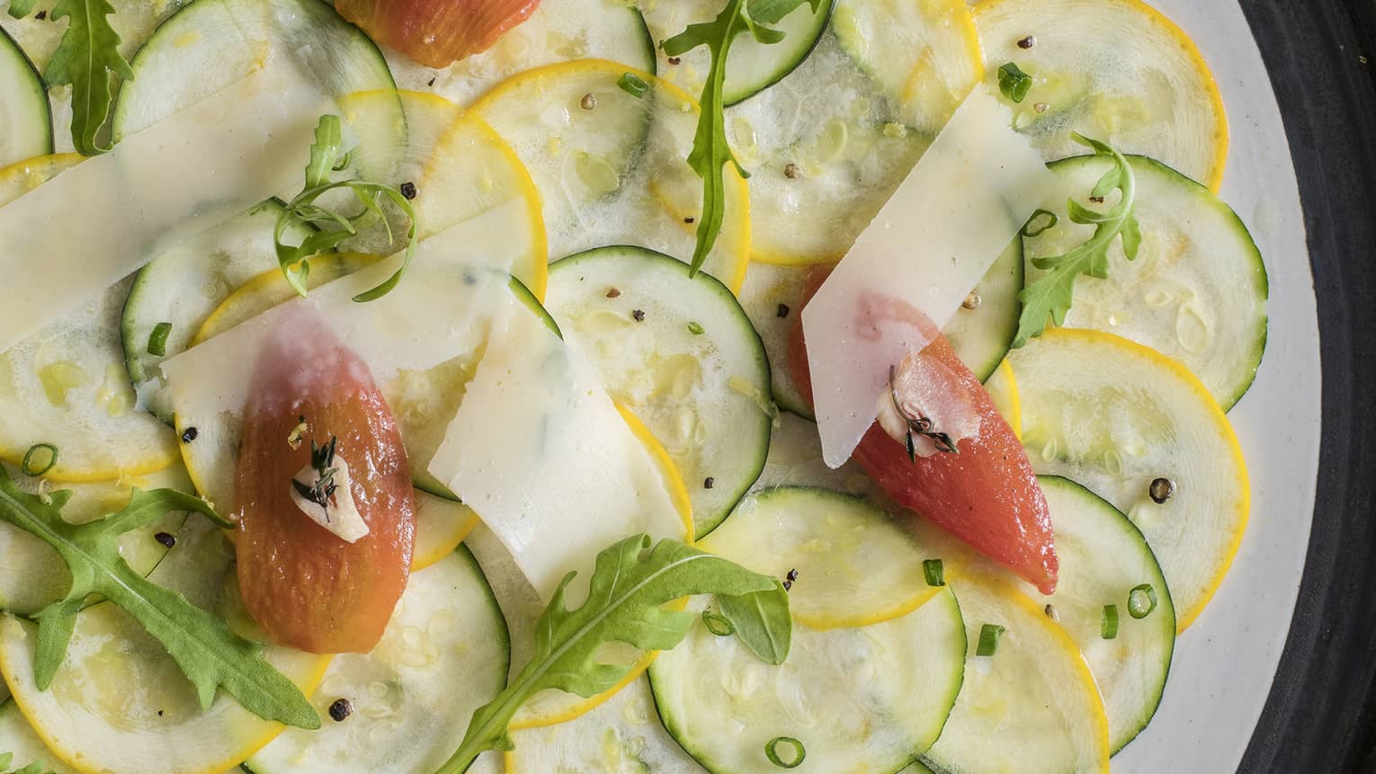 Zucchini carpaccio with sun-dried tomato, parmesan, chive, lemon zest and arugula