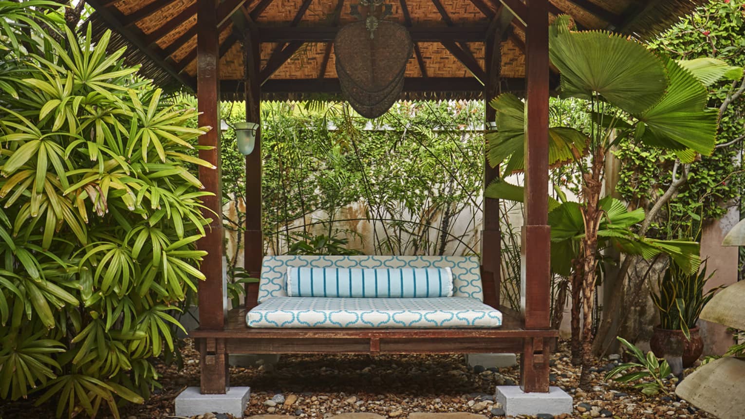 Seating in a spa courtyard surrounded by tropical plants