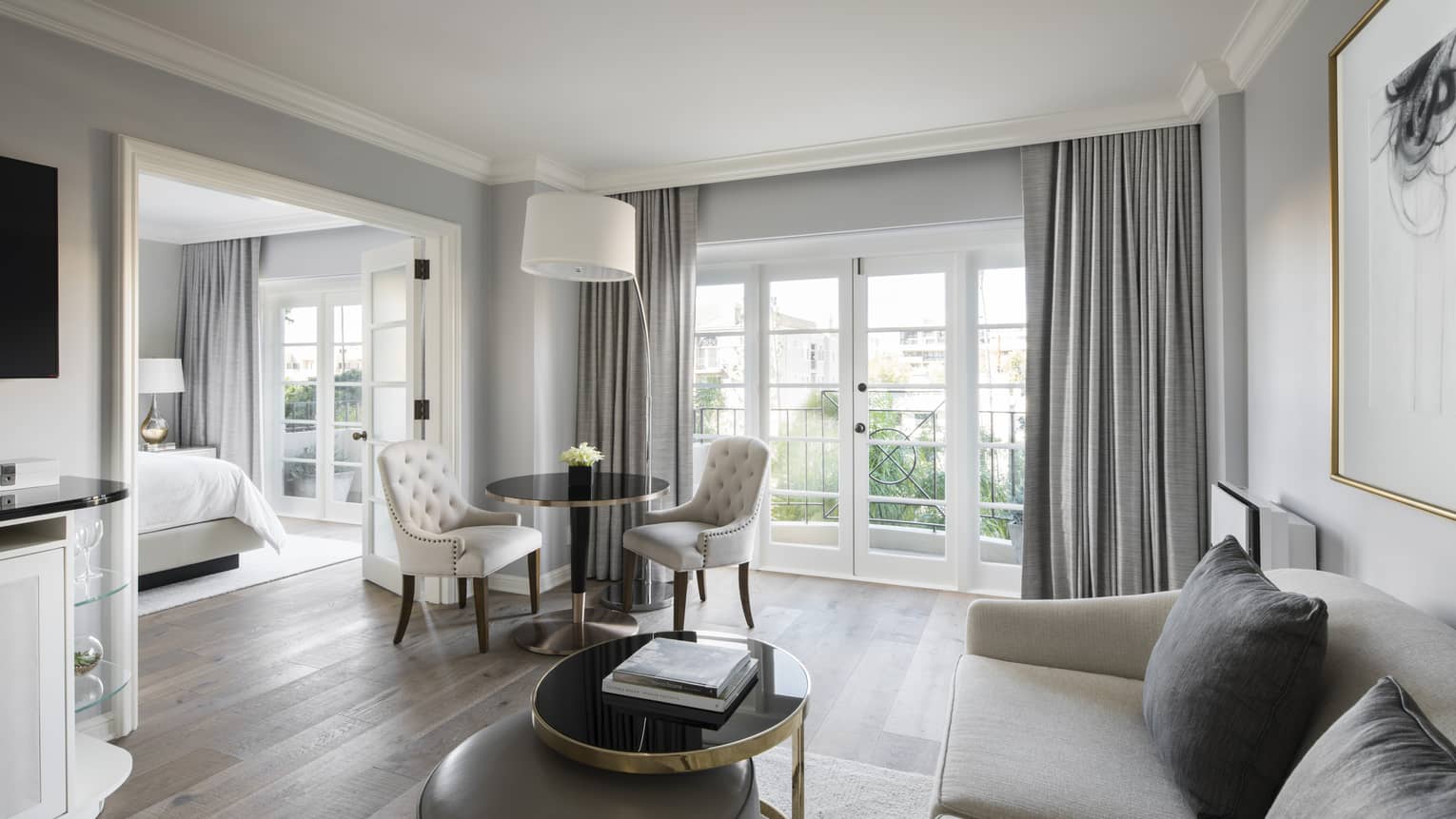 Deluxe Balcony Wellness Room bright living room sofa, table by balcony doors, French doors to bedroom