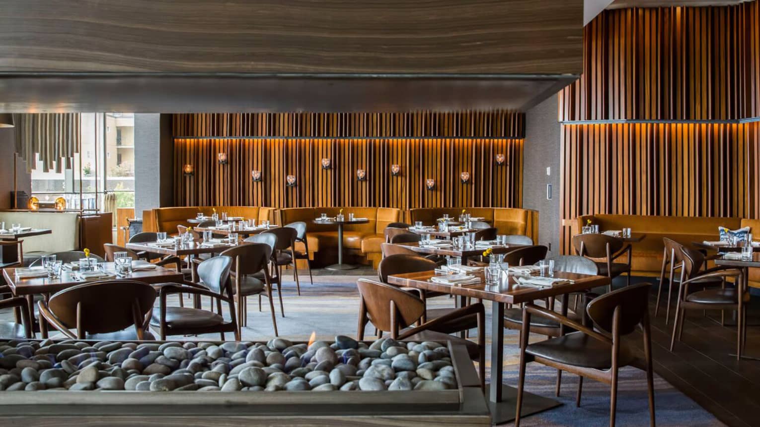 Goldfinch Tavern dining room beyond modern wood-and-stone gas fireplace
