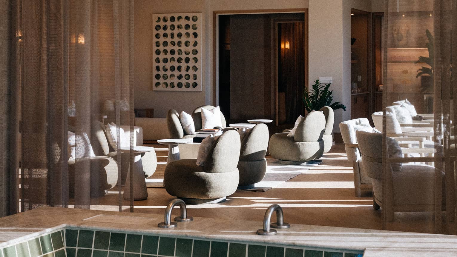 A spa pool and lounge area illuminated by sunlight
