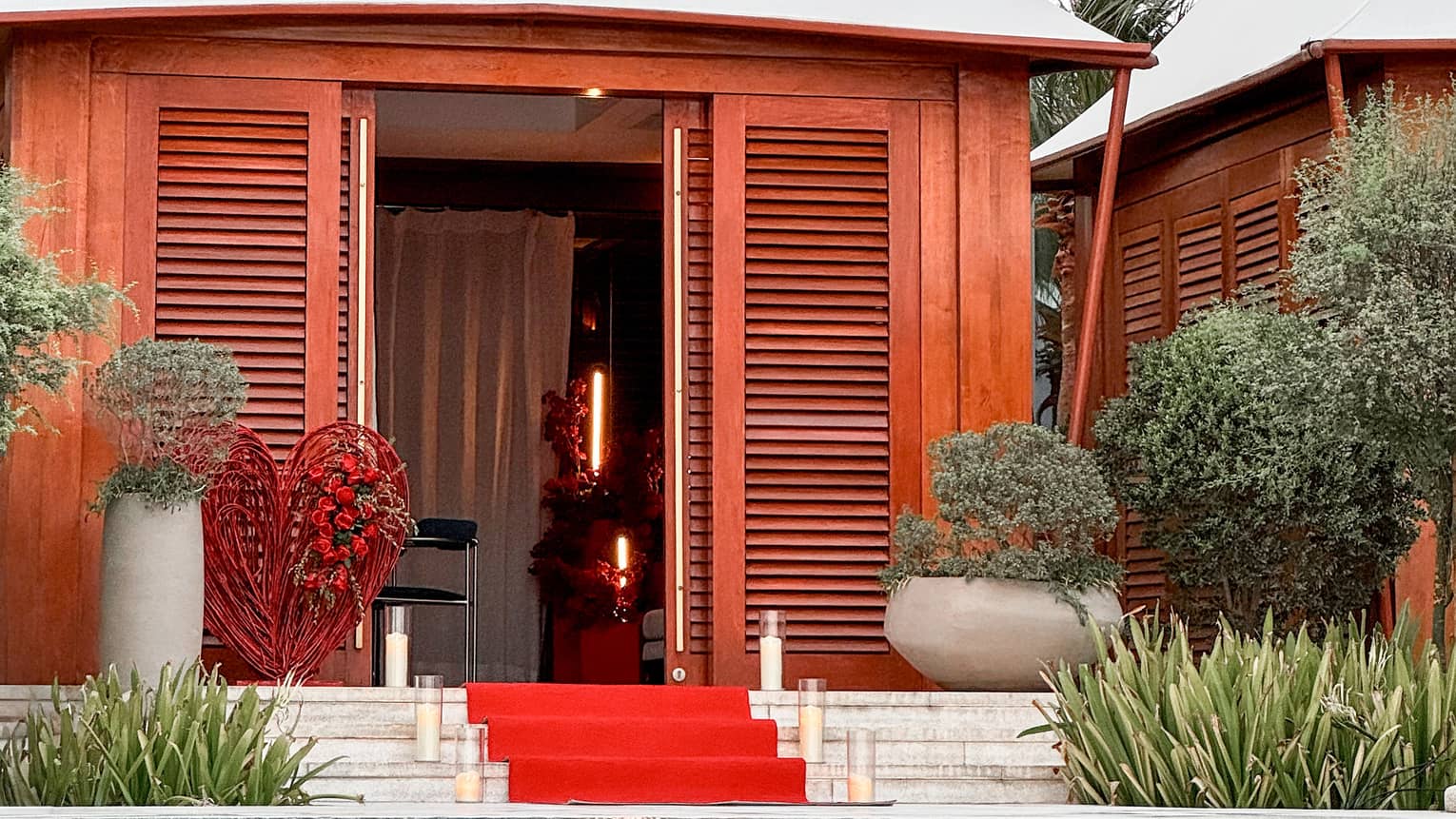 Poolside cabana with red carpet leading up to the entrance