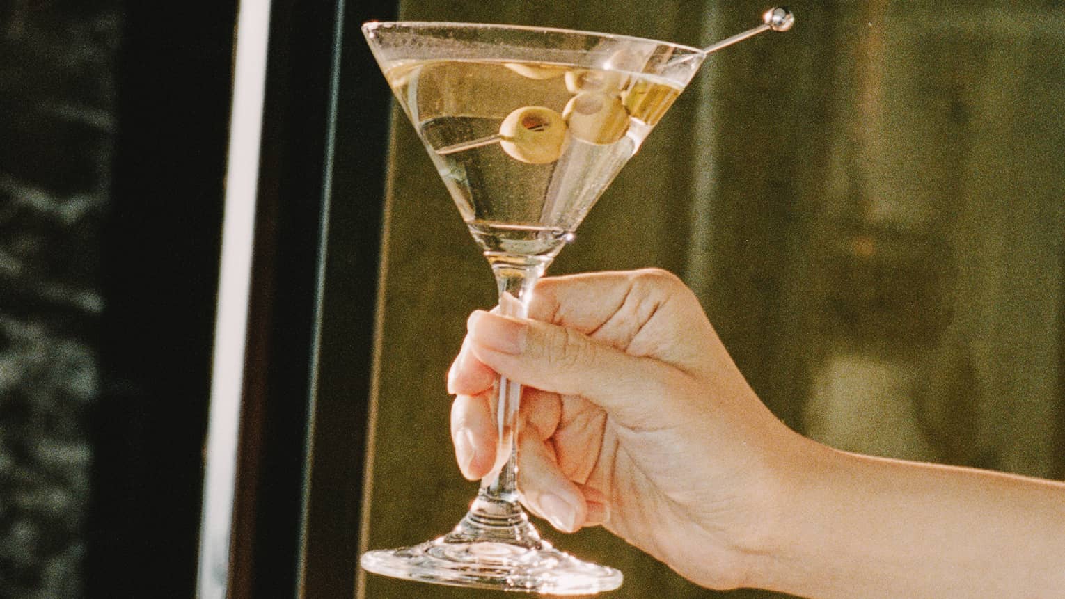 Hand holding a martini