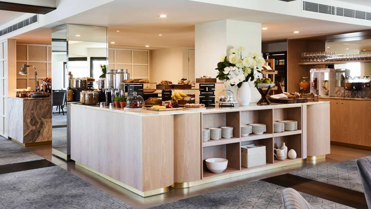 Lounge 32 open kitchen buffet with pastries, fresh fruits, flowers