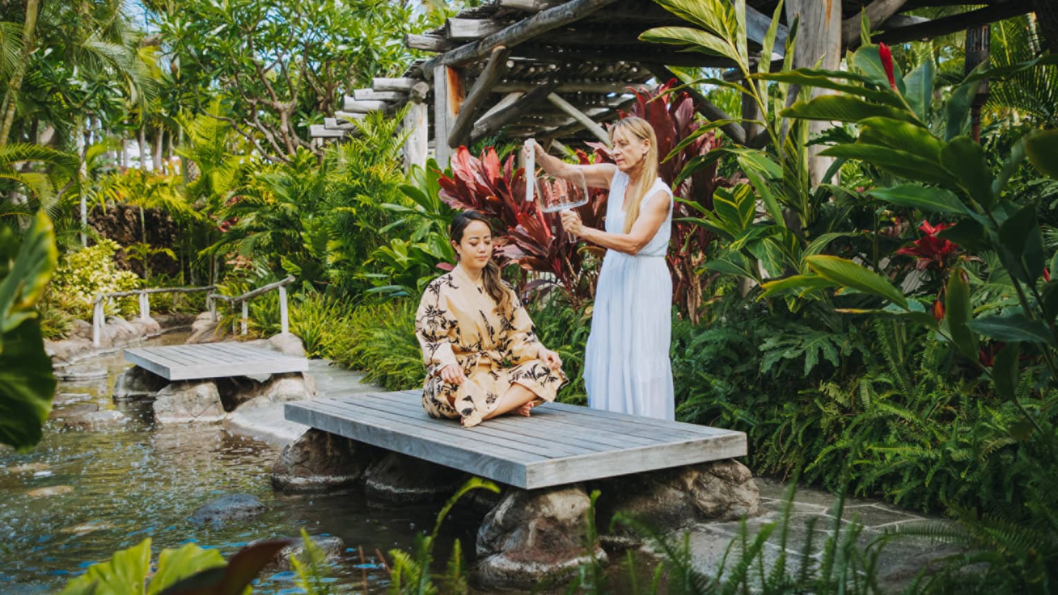 A guest having a relaxing spa treatment outside in Hualalai