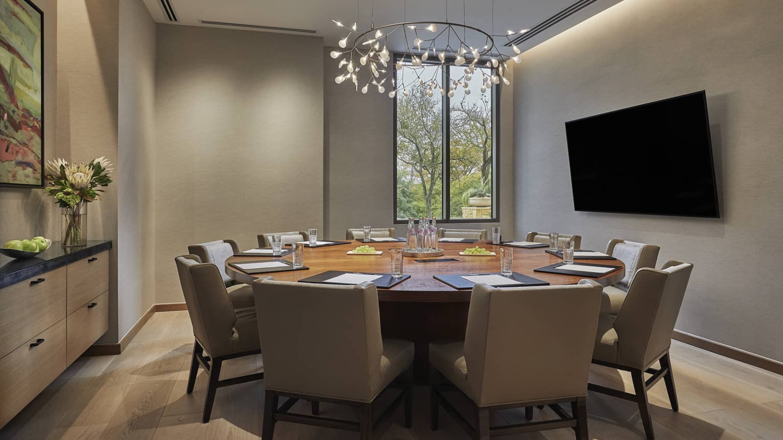 Shoal Creek meeting room with small round table, large chairs, screen