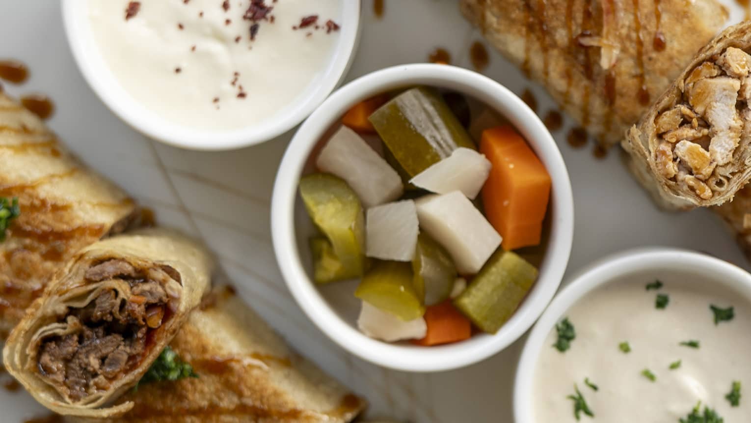 Shawarma and dipping sauces.