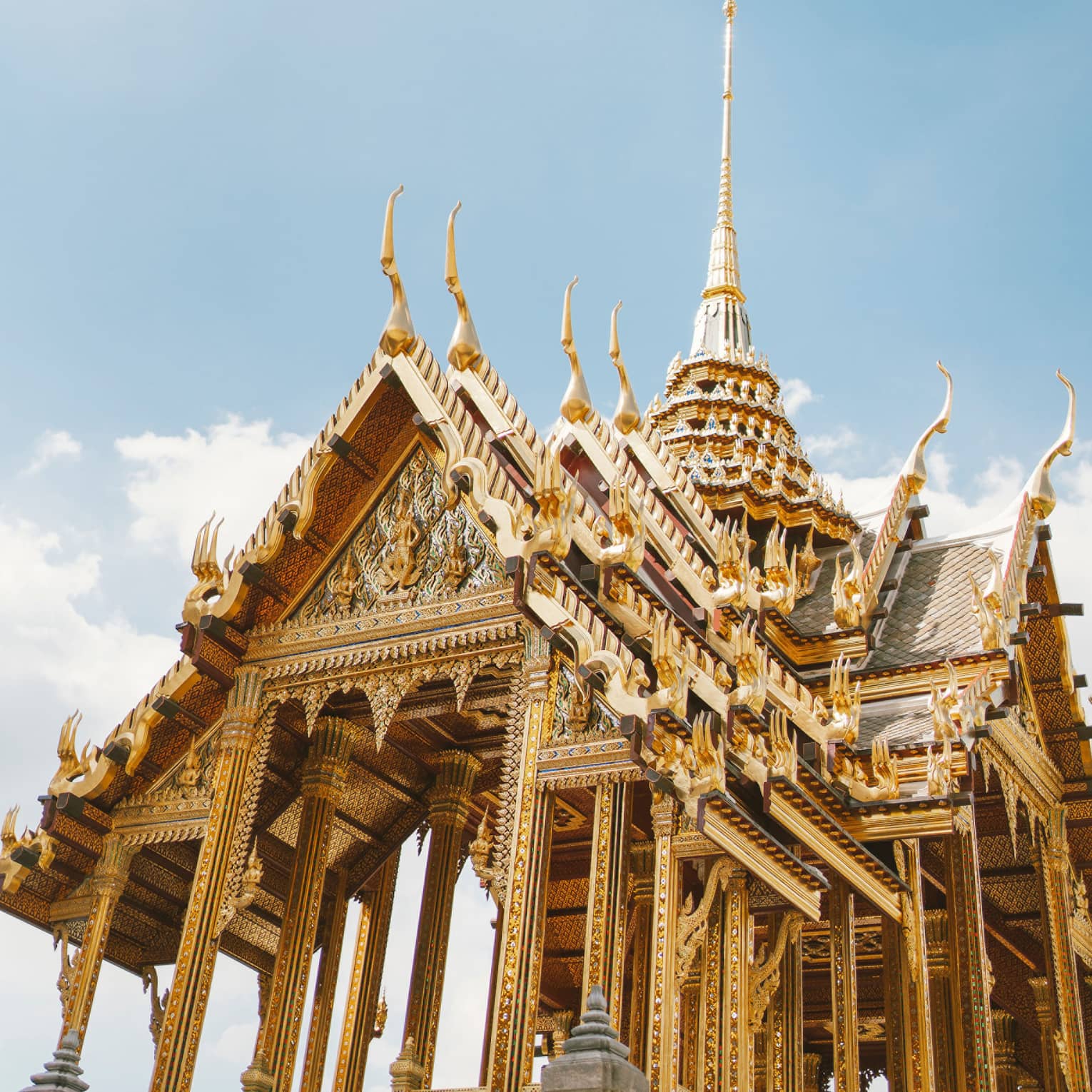 Wat Ratchabophit temple architecture against blue sky, white clouds