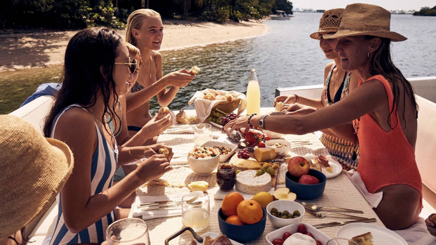 A group of women eating on a boat.