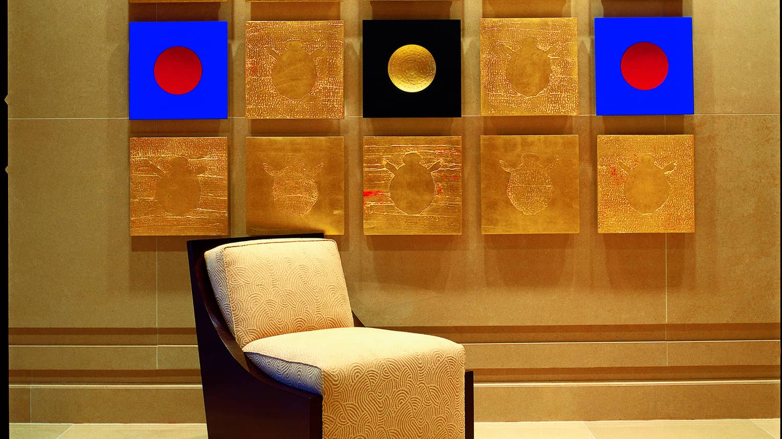 Close-up of colourful modern art painting made up of 15 squares of gold, bright blue, red and black images