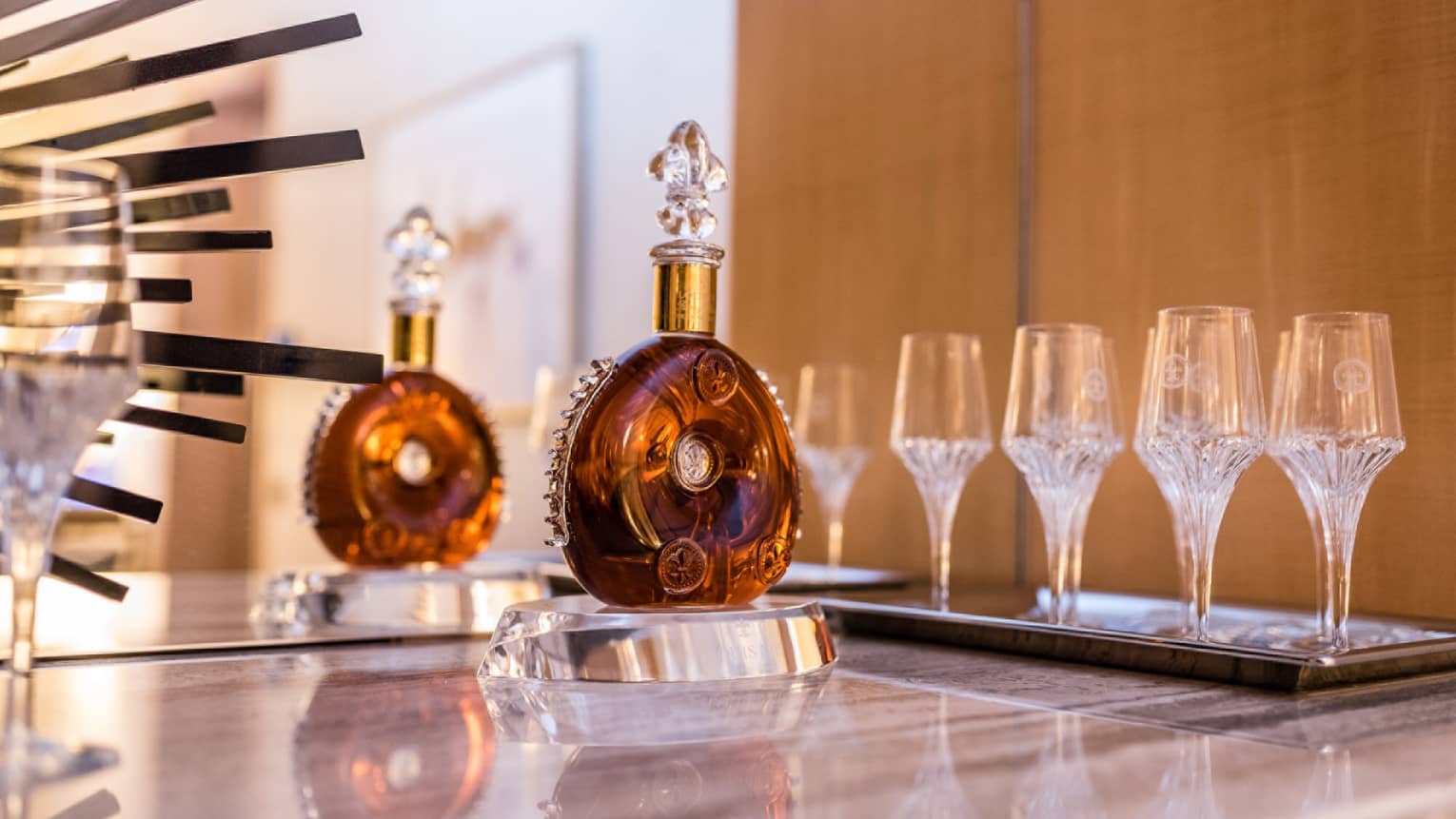 Doughnut shaped Cognac bottle with glass stopper and set of glasses for tasting 
