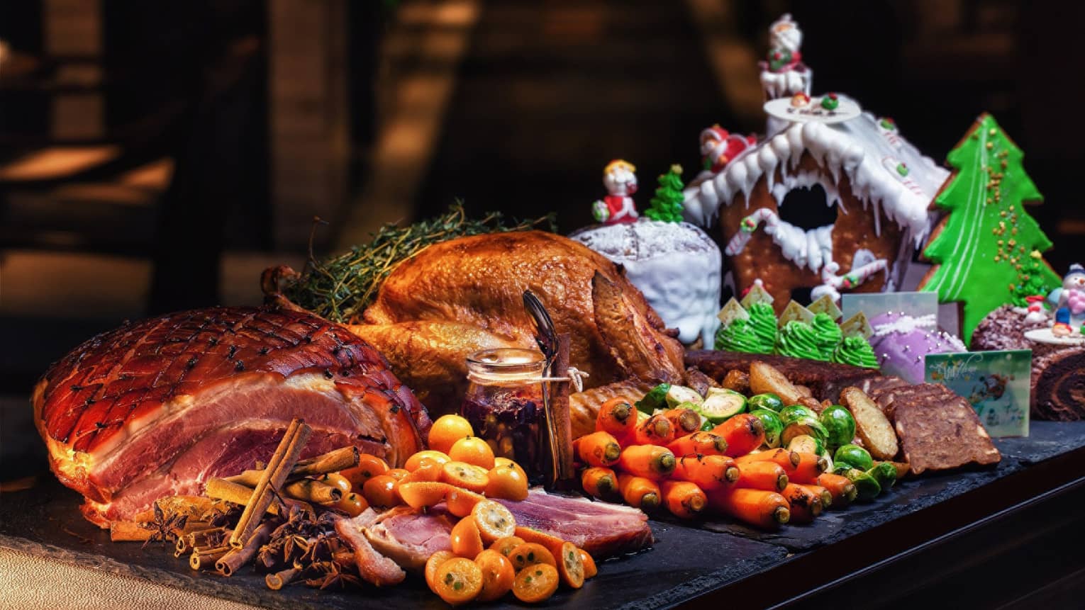 Christmas dinner with turkey and vegetables with gingerbread house on the side