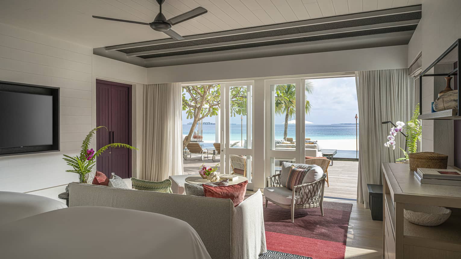 Resort bedroom with two beds, sitting area and walk-out, beachfront terrace