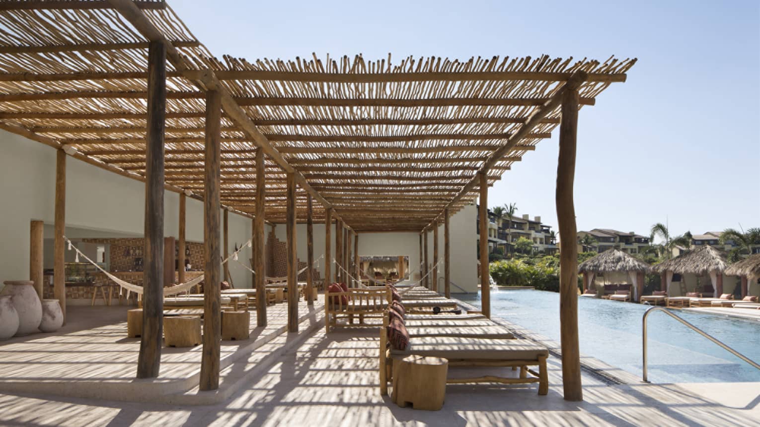 Poolside lounge under thatched roof