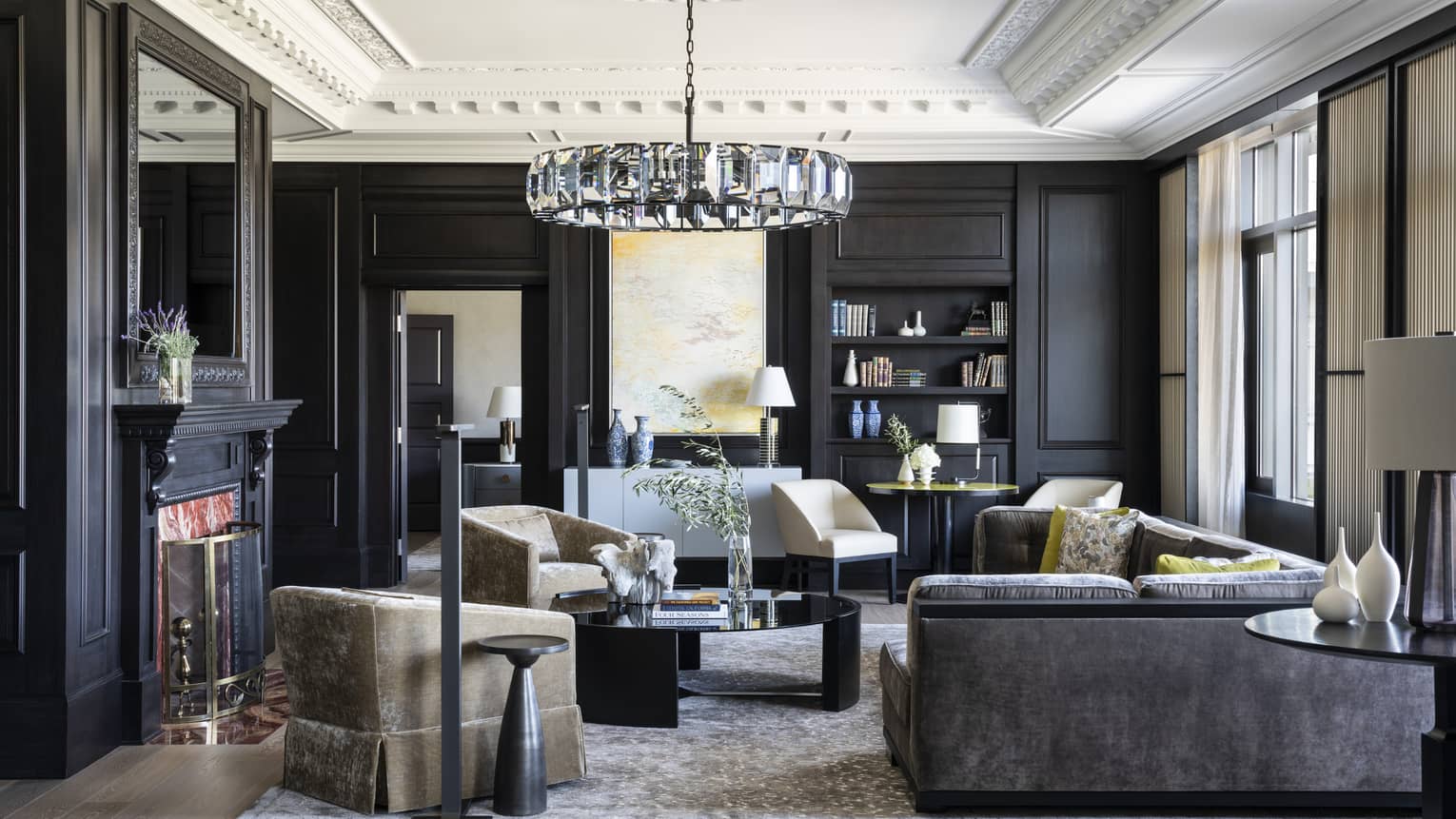 Dark-panelled walls and a white ceiling with extensive crown molding adorn the Presidential Suite's living room