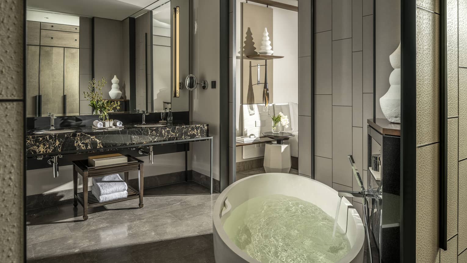 Guest bathroom, large mirror, standalone white tub, opening to bedroom