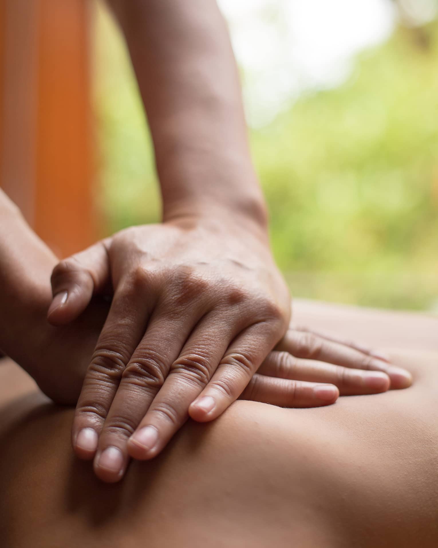 Close up of hands massaging a back