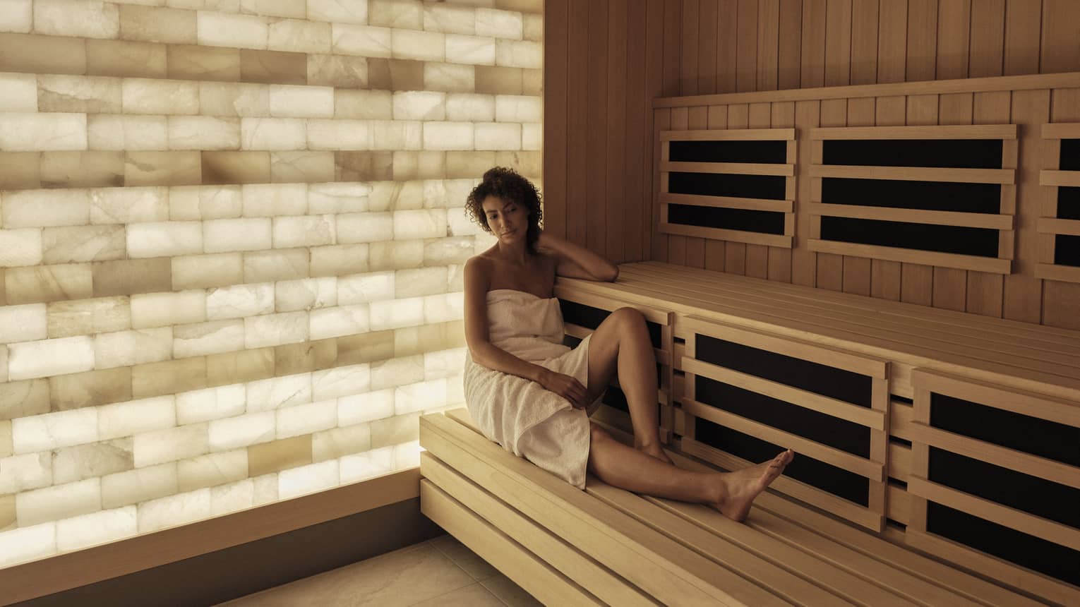 Woman relaxes in the salt-wall sauna