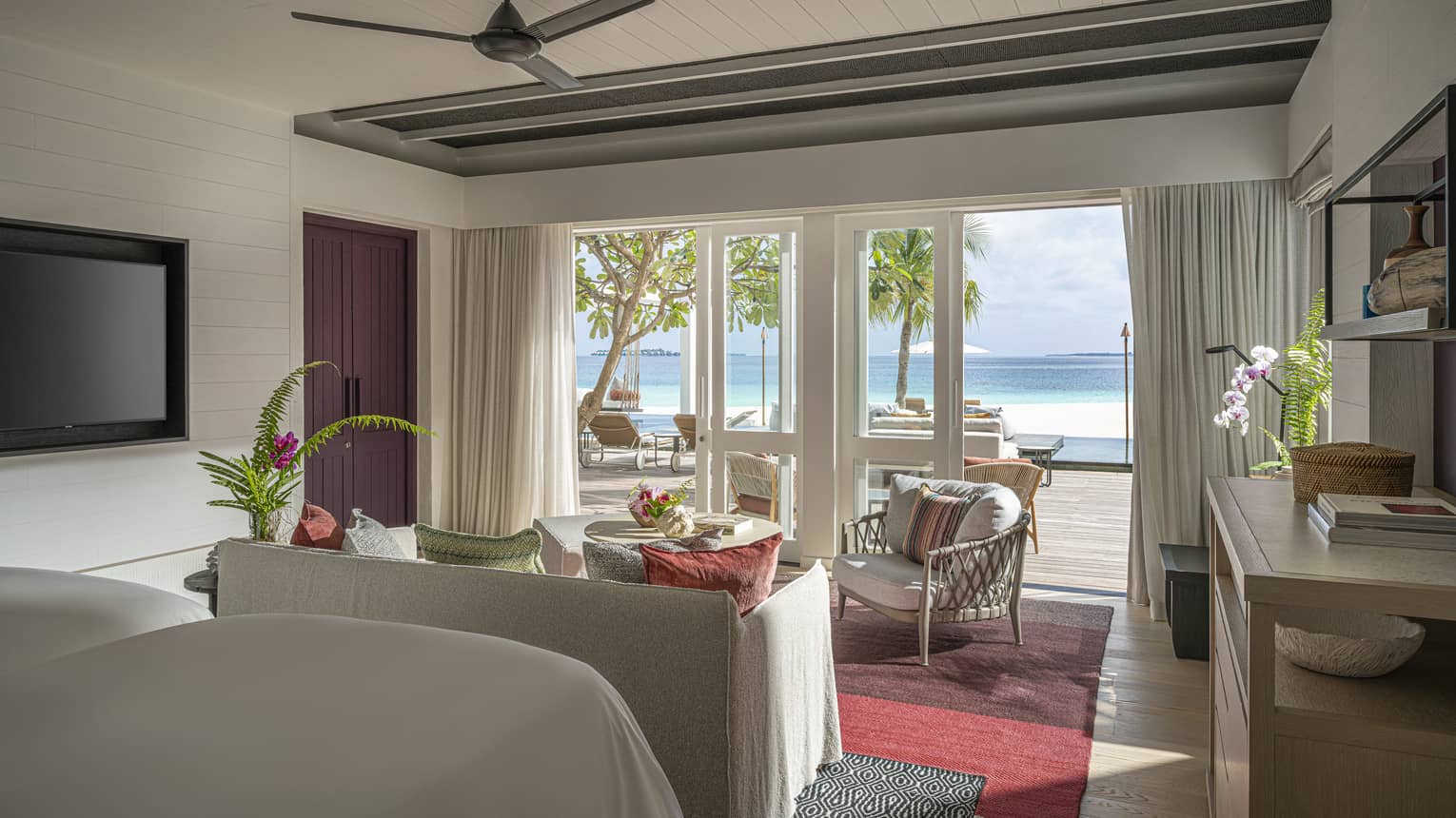 Resort bedroom with two beds, sitting area and walk-out, beachfront terrace