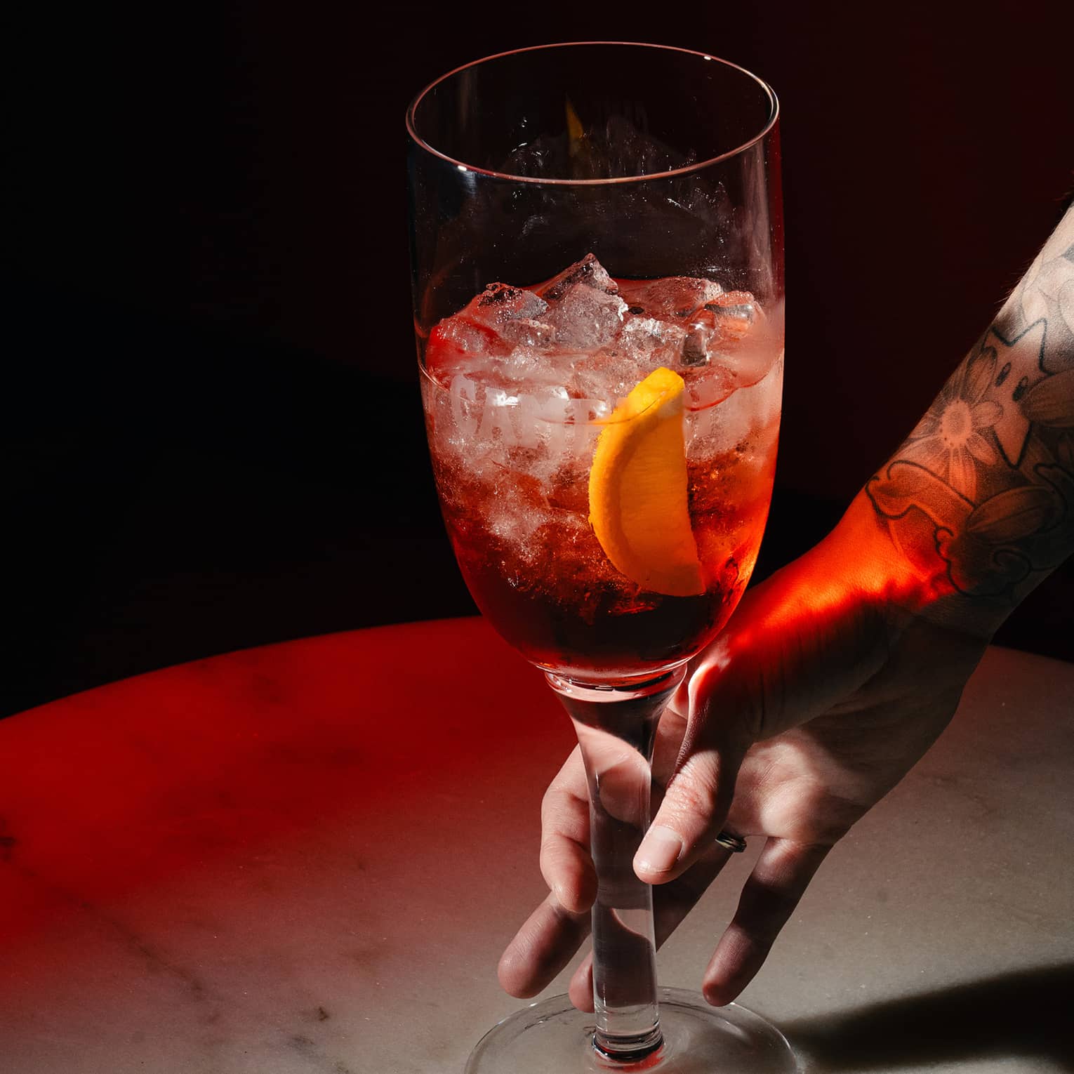 Sbagliato cocktail garnished with an orange slice
