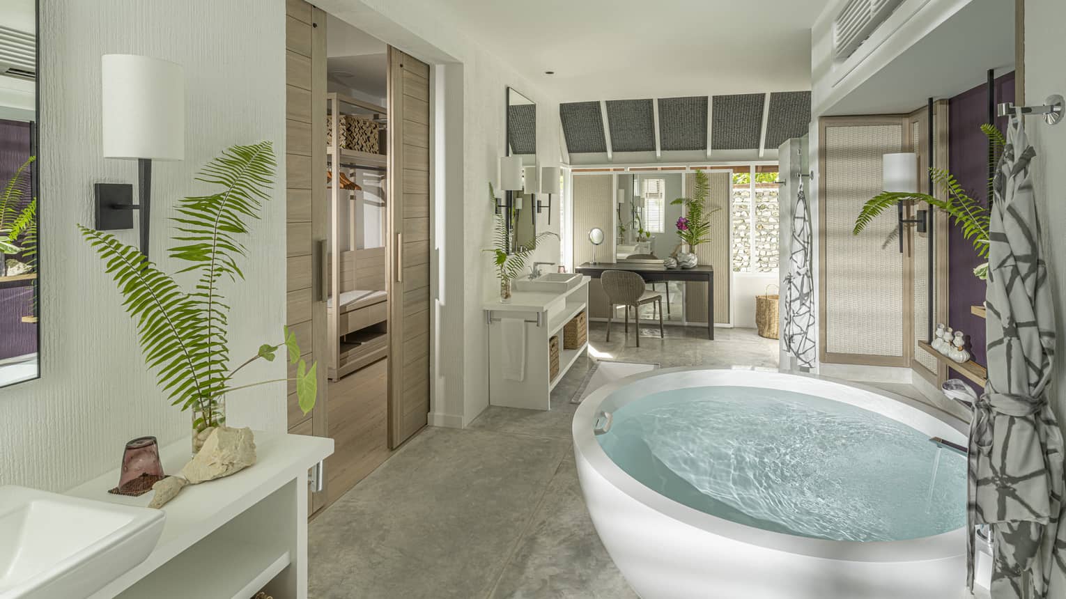 Large luxury resort bathroom with a free-standing circular tub