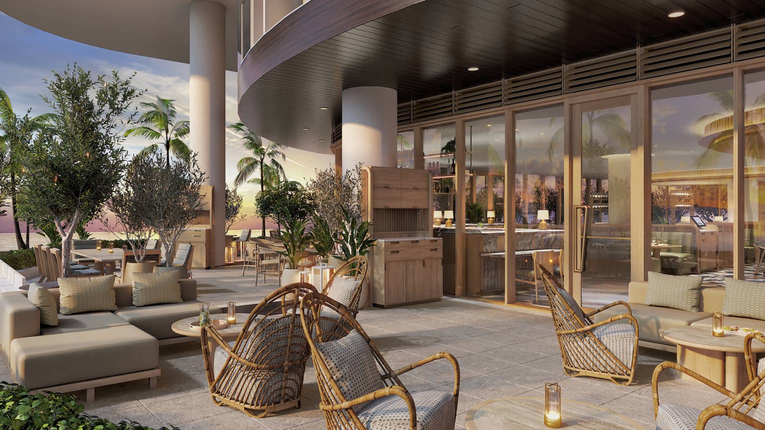 The exterior seating area of a restaurant, with chairs, tables and sofas.