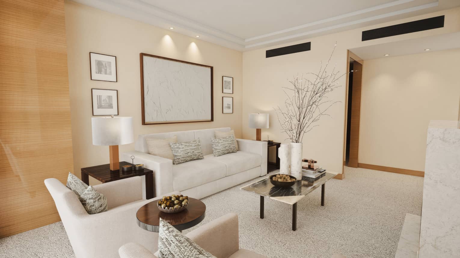 A luxury hotel suite living room featuring white sofa, two arm chairs, white carpet and ivory walls